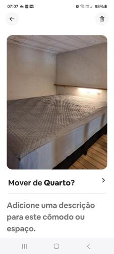 a bed with avertisement for at Loft centro do universo in Arroio do Sal