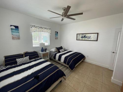 a bedroom with two beds and a ceiling fan at Sunset Bliss in Abbeyville