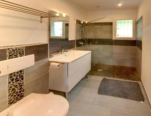 a bathroom with a sink and a toilet and a tub at Chez Muriel ou Chez Pierre in Porto-Vecchio