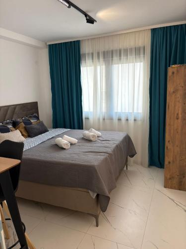 a bedroom with a bed with two towels on it at Nik 2 in Kruševac