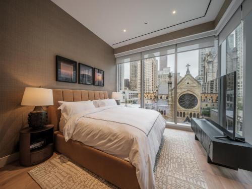 a bedroom with a bed and a large window at Stay One Chicago in Chicago