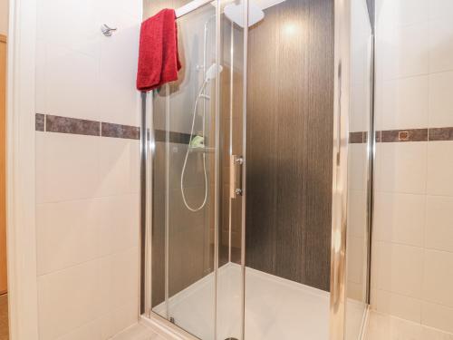 a shower with a glass door in a bathroom at Cairndhu in Boʼness
