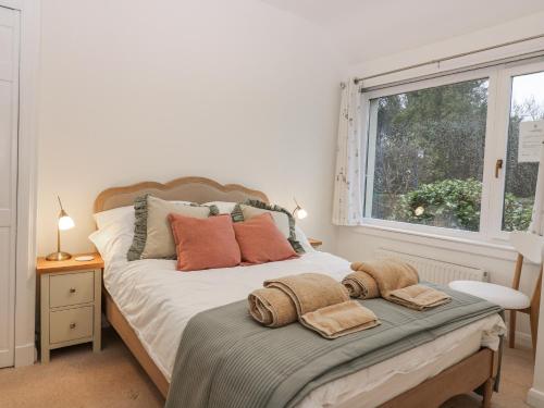 a bedroom with a bed with towels on it at Cairndhu in Boʼness
