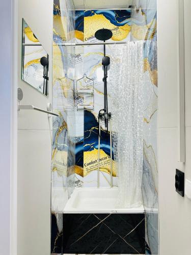 a shower in a bathroom with a shower curtain at Pulse capsule hotel in Almaty
