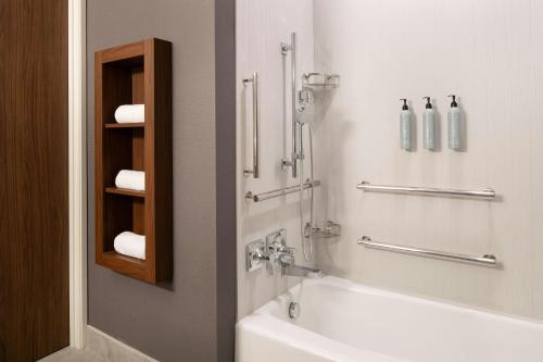 a bathroom with a tub and a sink and a shower at Courtyard by Marriott Sand City Monterey in Sand City