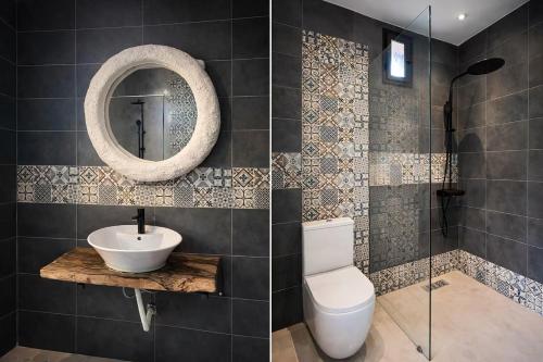 a bathroom with a toilet and a sink and a mirror at Villa Al Firdaous in Tiznit