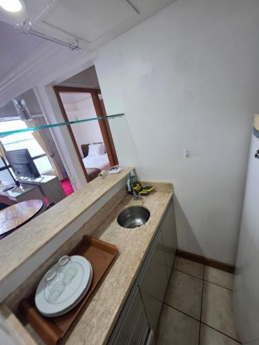 a bathroom with a sink and a mirror at tropical Flat Belissimo in Manaus