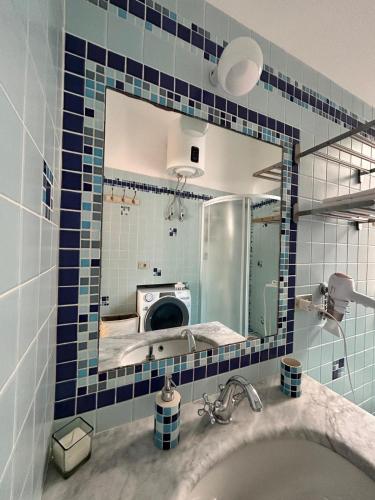 a bathroom with a sink and a mirror at Casa Amelia - Charme in Taormina in Taormina