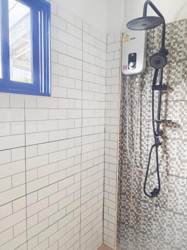 a shower with a shower curtain in a bathroom at Bangkok villa with 3 bedrooms in Ban Zong Katiam