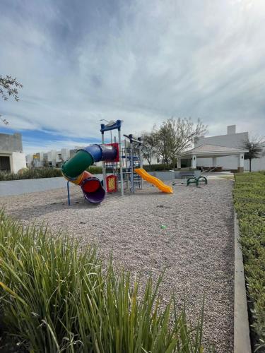 a playground with a slide in a park at Casa en fraccionamiento privado in Saltillo