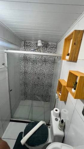 a bathroom with a shower with a toilet and a sink at Kit net morro de são Paulo in Cairu