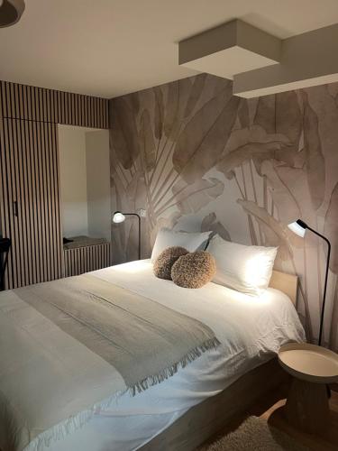 a bedroom with a bed with two pillows on it at Luméa 126 in Éguilles