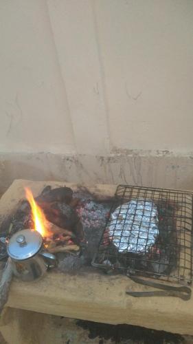 a fire in a brick oven with some food at Fekry house in Qaryat Ḩātim aţ Ţāʼī