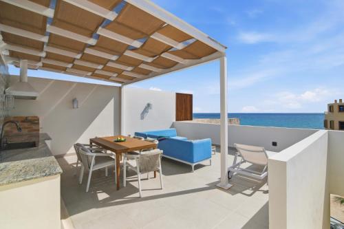 a patio with a table and chairs and the ocean at Ocean View Haven Walk to Beach Private Rooftop Terrace in Akumal