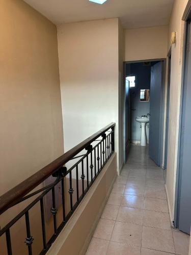 a hallway leading to a bathroom with a sink at Casa Quinta Real in Cedro