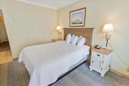 a hotel room with a bed and a table with a phone at New Oceanview, Low Floor, Heated Pools! in Myrtle Beach