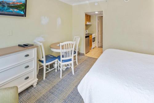 a bedroom with a bed and a table and chairs at New Oceanview, Low Floor, Heated Pools! in Myrtle Beach
