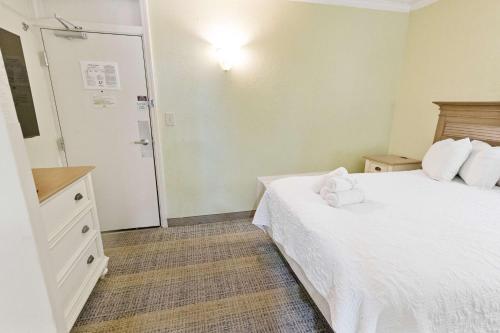 a hotel room with a bed and a bathroom at New Oceanview, Low Floor, Heated Pools! in Myrtle Beach