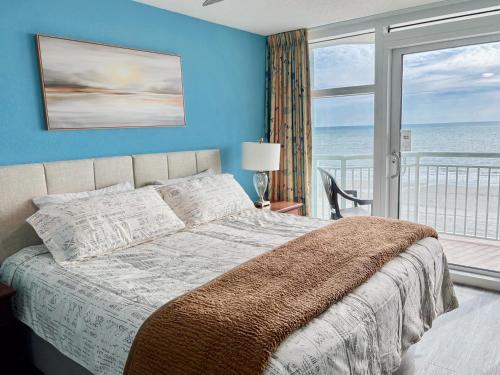 a bedroom with a bed with a view of the ocean at Amazing Oceanfront Home HS 4th Floor in Myrtle Beach