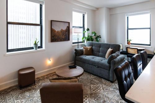 a living room with a couch and a table at Luxury Downtown Apt with Parking, Gym, and Lap Pool in Milwaukee
