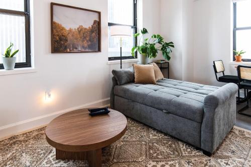 a living room with a couch and a table at Luxury Downtown Apt with Parking, Gym, and Lap Pool in Milwaukee