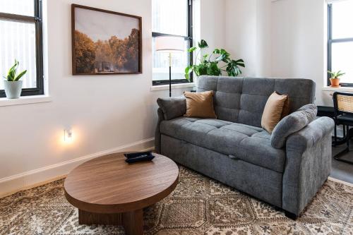 a living room with a couch and a table at Luxury Downtown Apt with Parking, Gym, and Lap Pool in Milwaukee