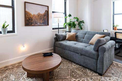 a living room with a couch and a table at Luxury Downtown Apt with Parking, Gym, and Lap Pool in Milwaukee