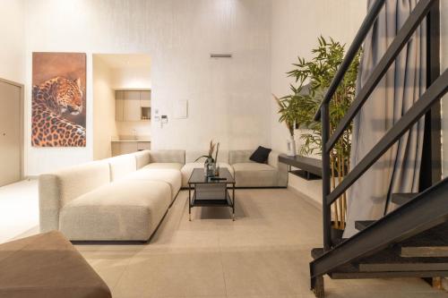 a living room with a couch and a table at TWENTY SIX ANFA LUXURY RESIDENCE by Shortstaymaroc -Hyper Centre -Parking in Casablanca