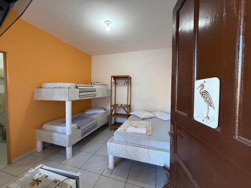 a room with two bunk beds and a mirror at Recanto Aconchego Itapoá in Itapoa