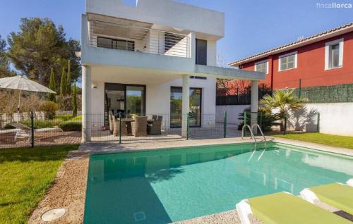 a house with a swimming pool in front of a house at Oasis N'aguait in Cala Ratjada