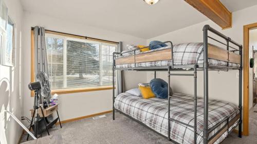 a bedroom with two bunk beds and a window at Mountain View Villa in Red Lodge