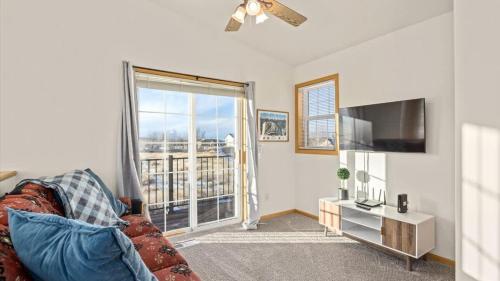 a living room with a couch and a flat screen tv at Mountain View Villa in Red Lodge