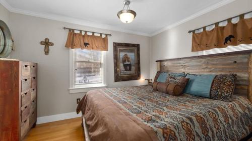 a bedroom with a large bed and two windows at Beartraks in Red Lodge