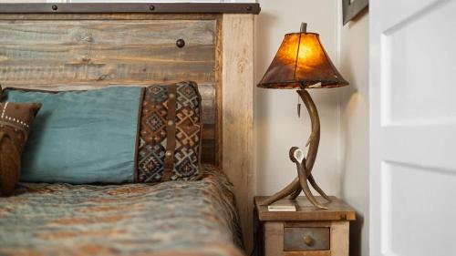 a lamp sitting on a night stand next to a bed at Beartraks in Red Lodge