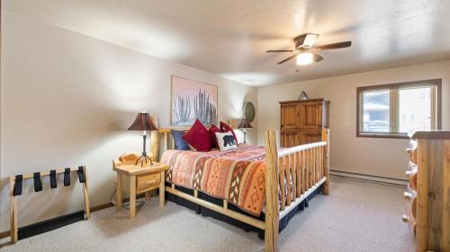 a bedroom with a bed and a ceiling fan at Putter`s Inn in Red Lodge