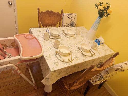 a table with plates and cups and a vase on it at Walk to Dodger St Echo Park Modern 2BR with 1Gbps Fiber Parking in Los Angeles
