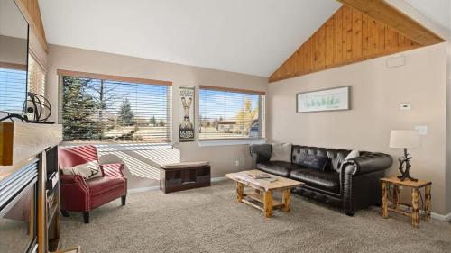 a living room with a couch and a table at Sans Souci Cabin in Red Lodge