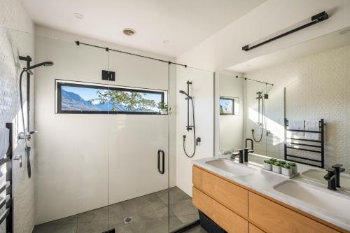 a bathroom with a glass shower and a sink at Blackwood Lakeview Retreat in Queenstown
