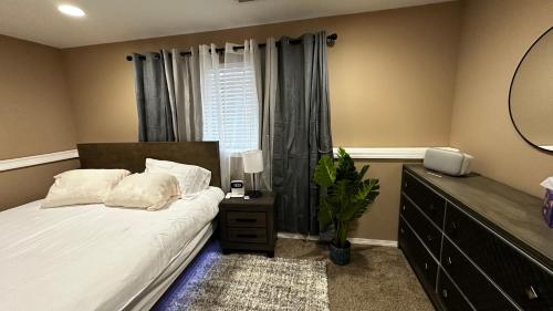 a bedroom with a bed with a dresser and a mirror at apartment unit in Spokane