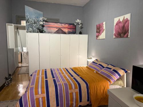 a bedroom with a bed and a white cabinet at Fly City châtelet in Châtelet