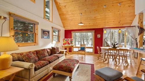 a living room with a couch and a table at Chickadee Chalet in Red Lodge