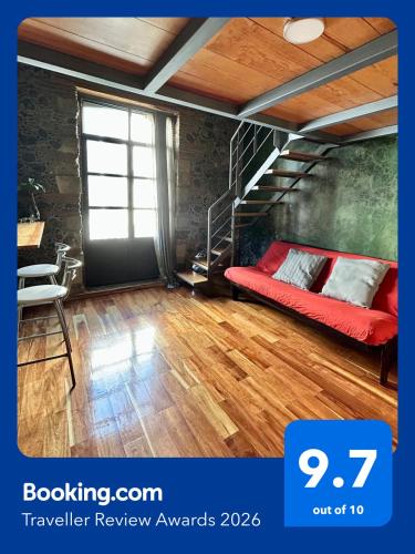 a bedroom with a red bed and a staircase at Latidos del Centro de CDMX in Mexico City