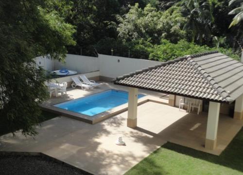 a backyard with a pool and a gazebo at Flat Aeroporto - Estrada do coco - Lauro de Freitas M in Lauro de Freitas