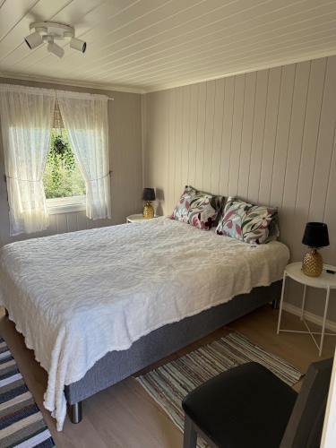 a bedroom with a large bed and a window at Ditt feriehjem! in Kristiansand