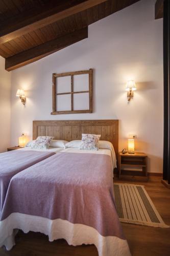 a bedroom with two beds and a window at El Paller de Casa Parramon in Peramea