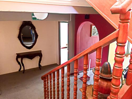 a staircase in a house with a mirror on the wall at Greenhouse Bolivia in La Paz
