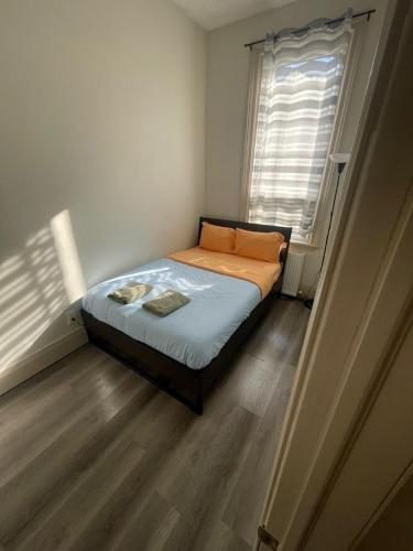 a small bedroom with a bed and a window at FIFA CENTRAL TORONTO-DIRECT TO BMO FIELD-Live Game Atmosphere-Free Wifi in Toronto