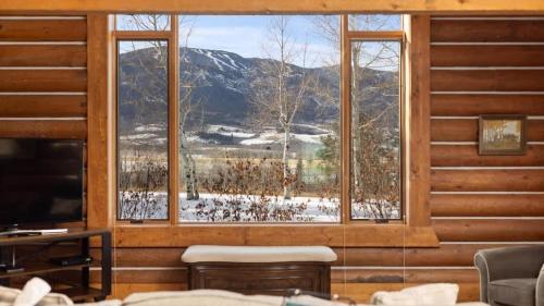 a room with a large window with a mountain view at Grizzly Peak Cabin in Red Lodge