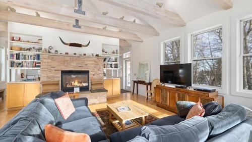 a living room with a couch and a fireplace at Mountain Treetop in Red Lodge