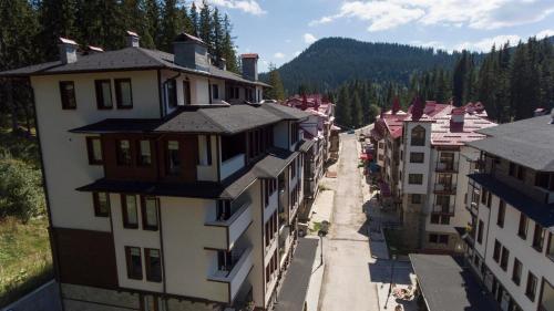 an aerial view of a town with buildings at Green Life Family Apartments Pamporovo in Pamporovo